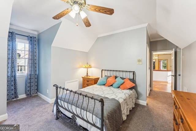 carpeted bedroom with ornamental molding, vaulted ceiling, and ceiling fan