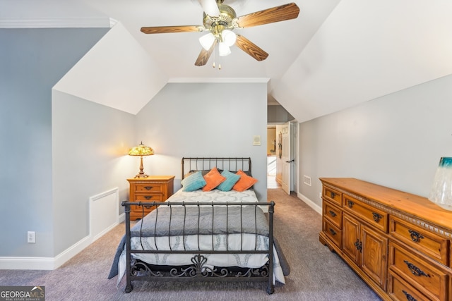 carpeted bedroom with ornamental molding, vaulted ceiling, and ceiling fan