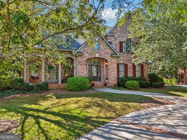 view of front facade with french doors and a front yard