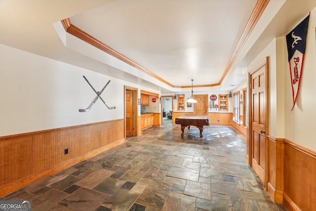 recreation room featuring ornamental molding, a tray ceiling, billiards, and wood walls