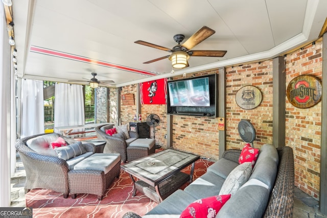 living room with brick wall and ceiling fan