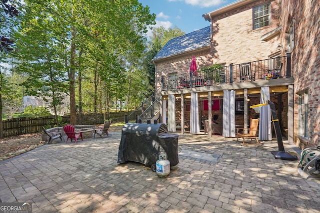 view of patio featuring a deck and a fire pit