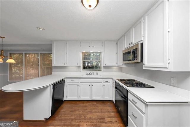 kitchen featuring white cabinets, black appliances, kitchen peninsula, and hanging light fixtures