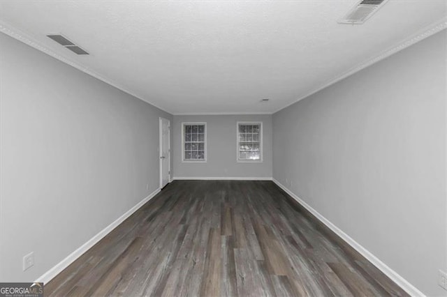 empty room with crown molding, a textured ceiling, and dark hardwood / wood-style flooring