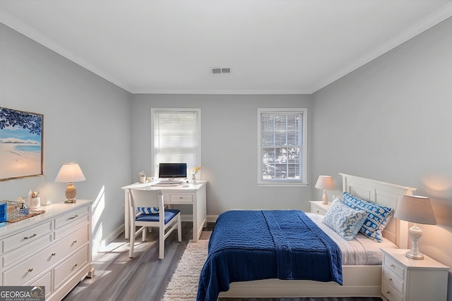 bedroom with crown molding and light wood-type flooring