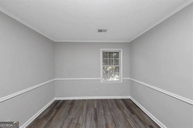 empty room with ornamental molding and dark wood-type flooring