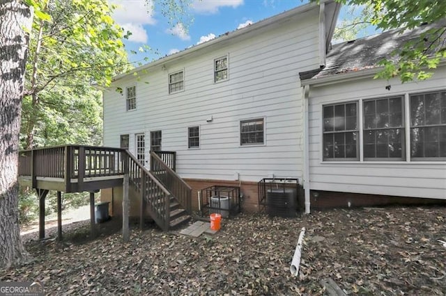 rear view of property featuring a wooden deck