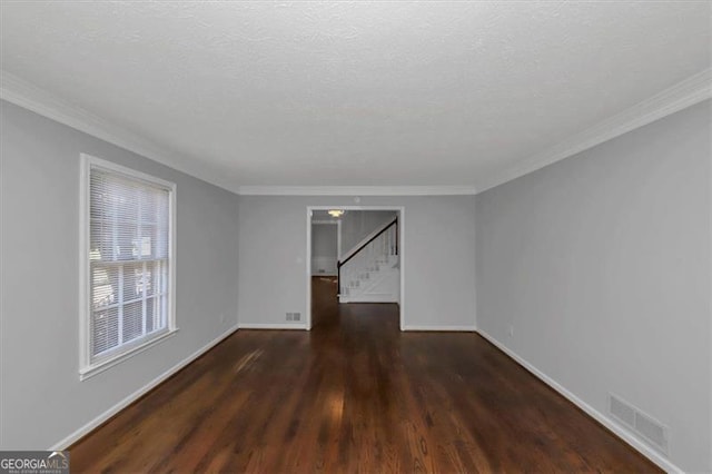 spare room with ornamental molding, a textured ceiling, and dark hardwood / wood-style flooring