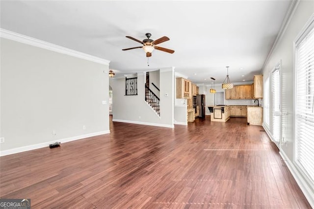 unfurnished living room with ornamental molding, sink, ceiling fan, and dark hardwood / wood-style flooring