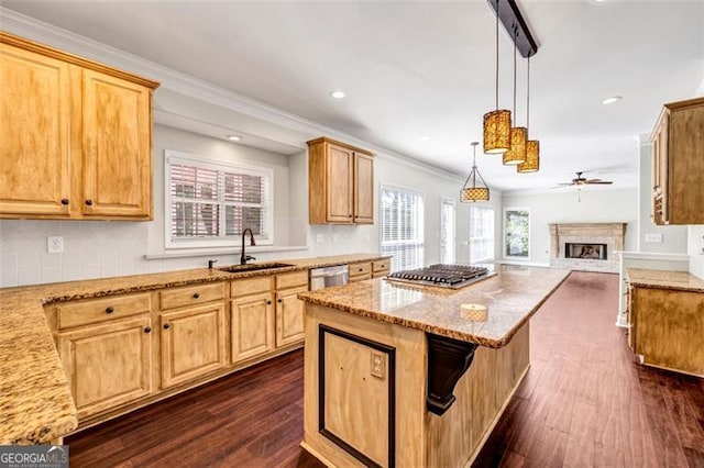 kitchen with sink, pendant lighting, dark wood-type flooring, light stone counters, and ornamental molding