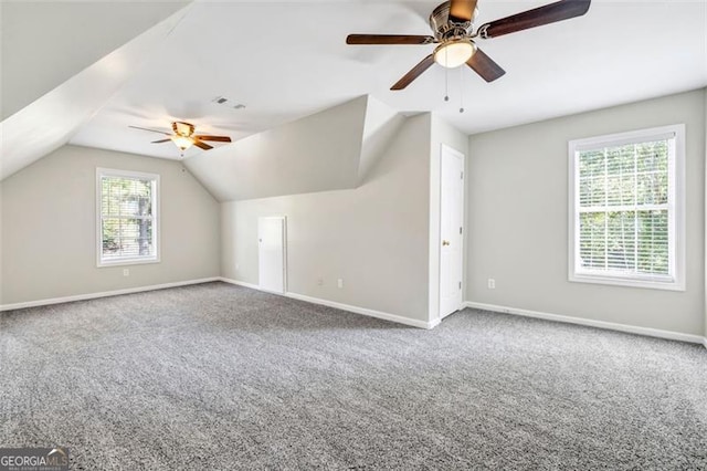 additional living space with ceiling fan, vaulted ceiling, and carpet floors