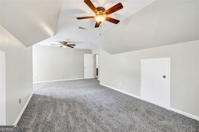 additional living space featuring carpet floors, ceiling fan, and vaulted ceiling