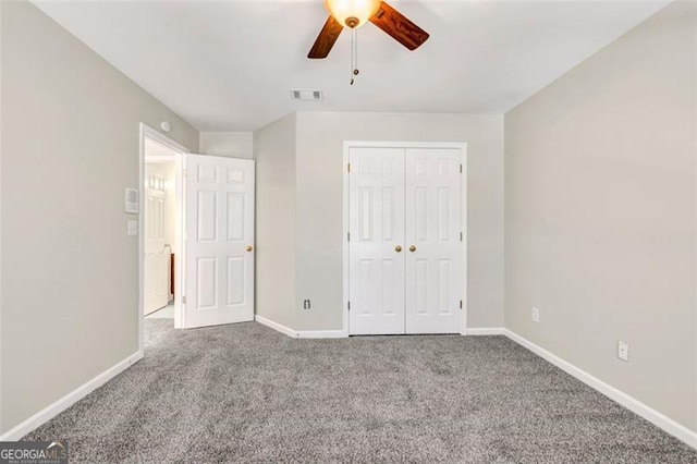 unfurnished bedroom featuring a closet, carpet, and ceiling fan