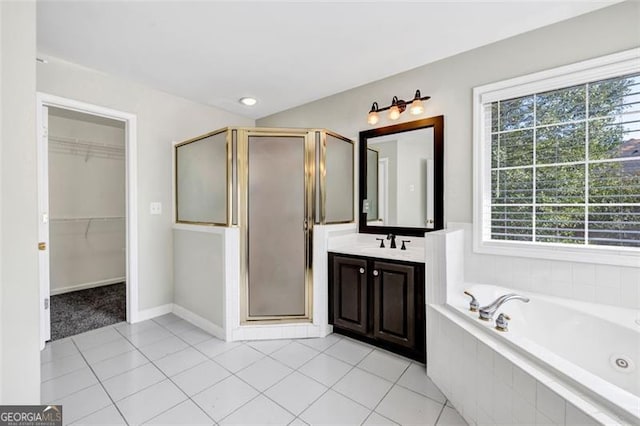 bathroom featuring vanity, plus walk in shower, and tile patterned flooring