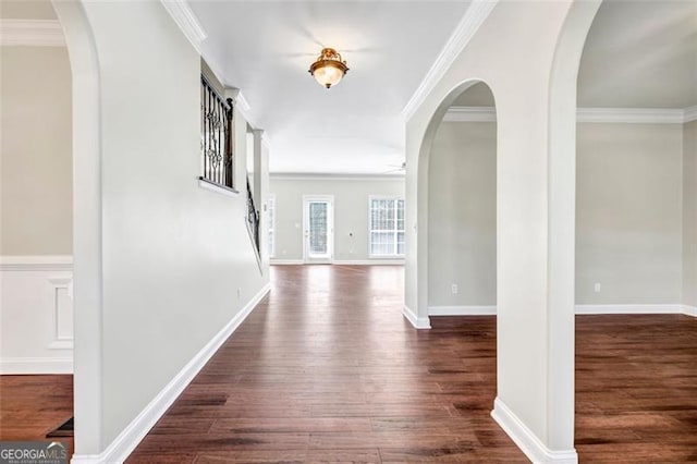 corridor with ornamental molding and dark hardwood / wood-style floors