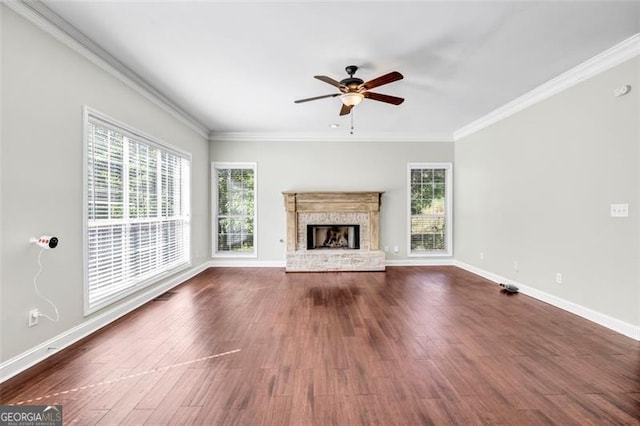 unfurnished living room featuring ornamental molding, dark wood-type flooring, and ceiling fan