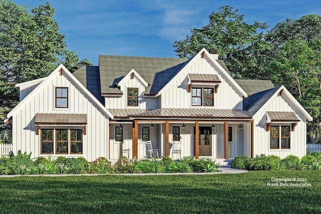 modern farmhouse style home featuring covered porch and a front yard