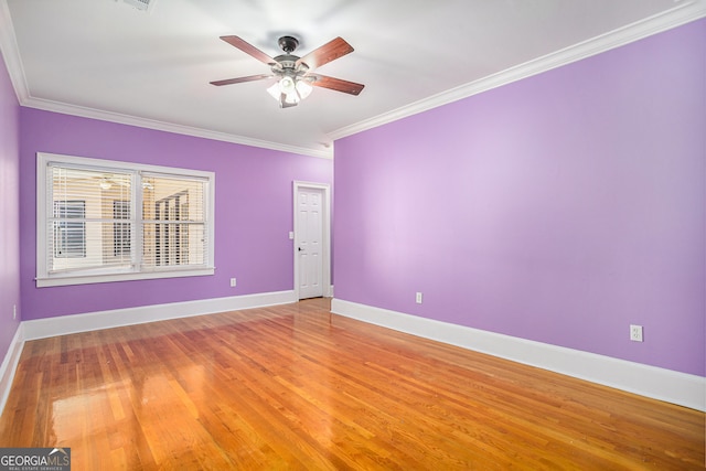 empty room featuring ornamental molding, hardwood / wood-style floors, and ceiling fan