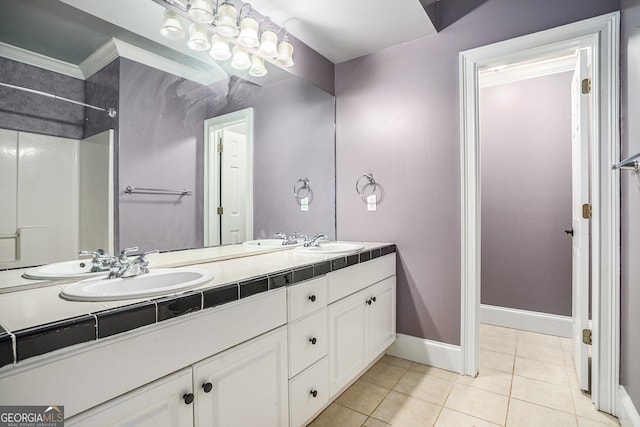 bathroom featuring vanity, ornamental molding, and tile patterned flooring