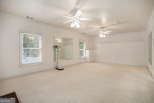 empty room featuring ornamental molding, light carpet, and ceiling fan