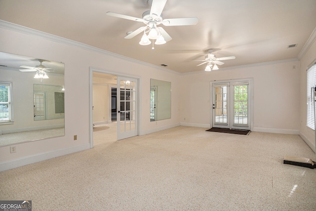 carpeted empty room featuring french doors, crown molding, and ceiling fan