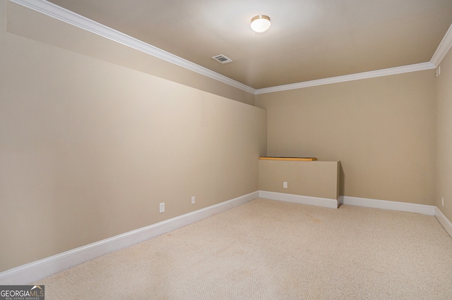 spare room featuring crown molding and carpet