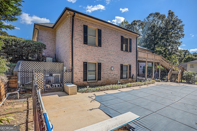 back of house featuring a patio and a pool side deck