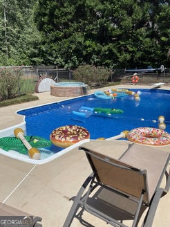 view of swimming pool with a patio area