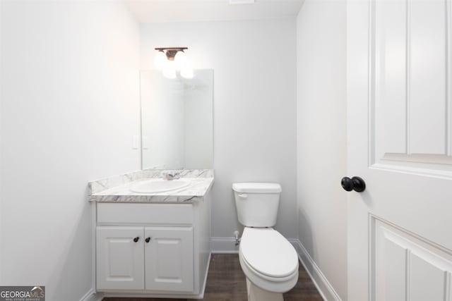 bathroom featuring vanity, toilet, and wood-type flooring