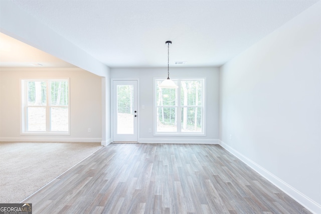 spare room with light hardwood / wood-style flooring