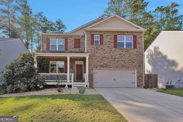 view of front of home featuring central AC, a porch, a front lawn, and a garage