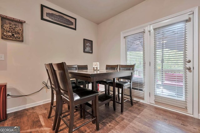 dining space with dark hardwood / wood-style flooring