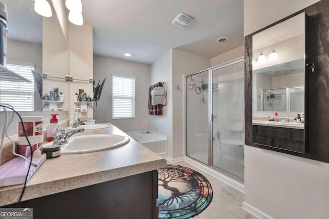 bathroom featuring vanity, a shower with shower door, and tile patterned floors