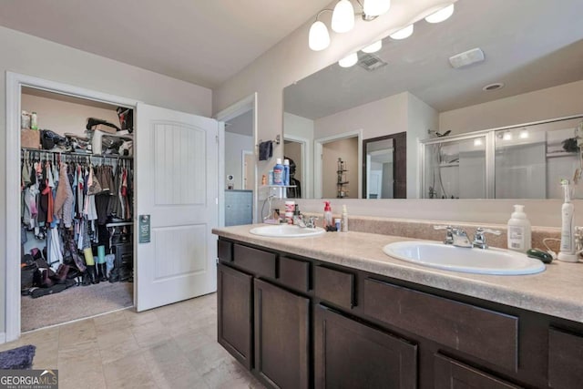 bathroom with vanity and a shower with shower door