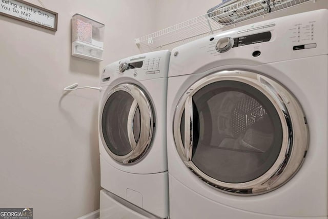 laundry area with washing machine and clothes dryer