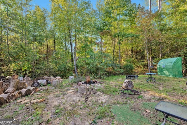 view of yard with a fire pit