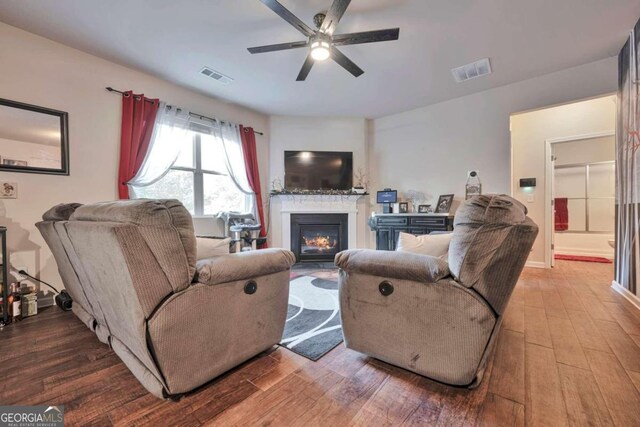 living room featuring hardwood / wood-style floors and ceiling fan