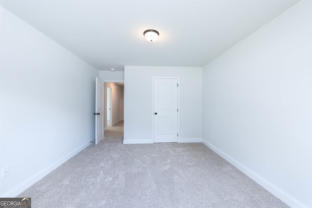 unfurnished bedroom with light colored carpet