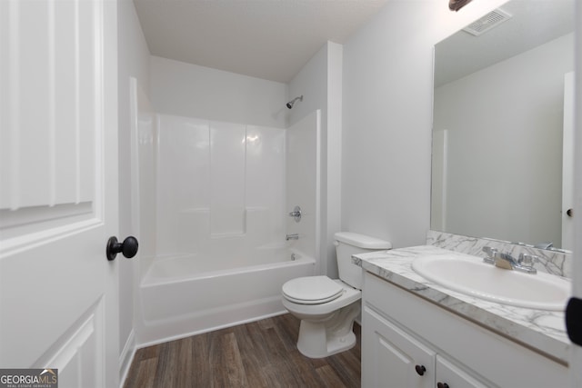 full bathroom with vanity, toilet, shower / washtub combination, and hardwood / wood-style floors