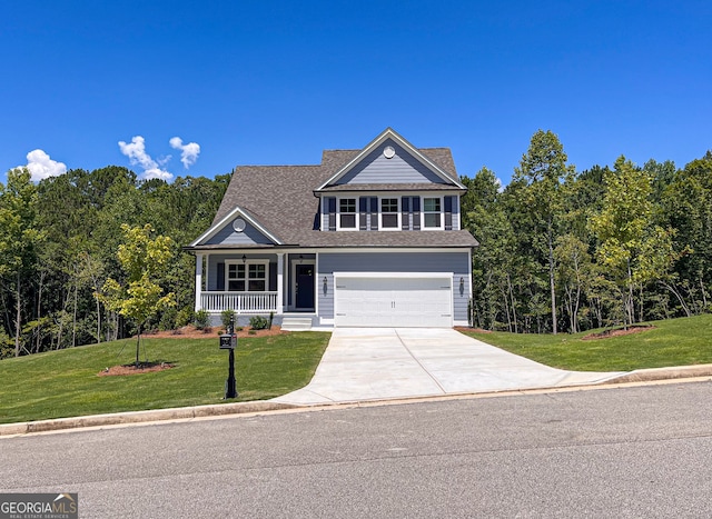 view of front of house with a front yard, a porch, and a garage