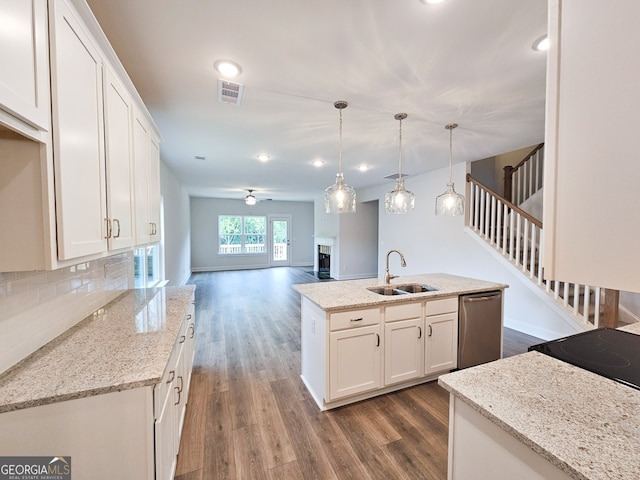 kitchen featuring white cabinets, dishwasher, dark hardwood / wood-style floors, and pendant lighting