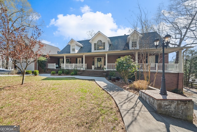 cape cod house with a porch and a front lawn