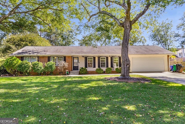 ranch-style house featuring a garage and a front lawn