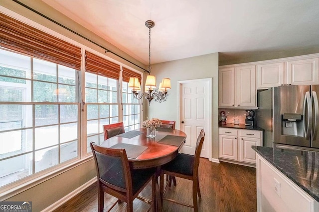 dining room featuring dark hardwood / wood-style floors and a notable chandelier