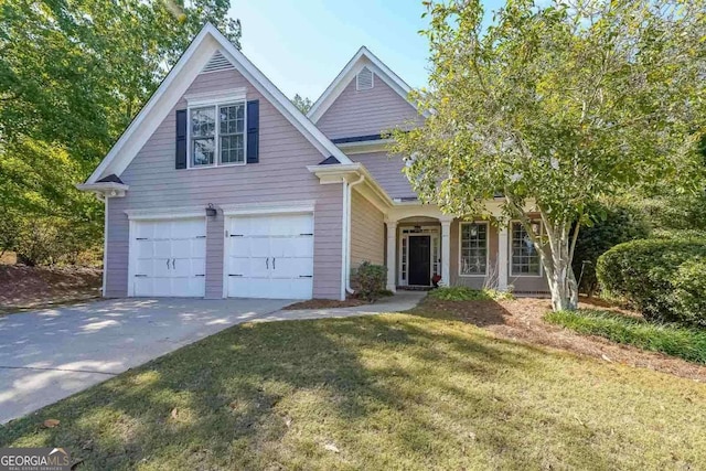 view of front of property with a garage and a front lawn