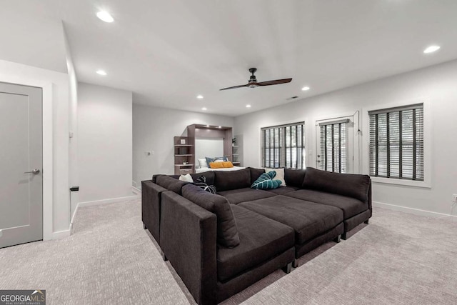 living room with ceiling fan and light colored carpet