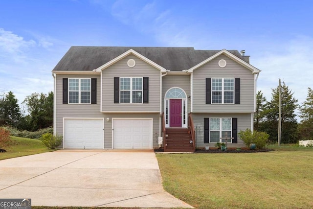 split foyer home featuring a front lawn and a garage