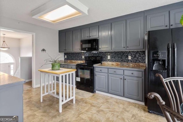 kitchen featuring gray cabinetry, black appliances, pendant lighting, a textured ceiling, and tasteful backsplash