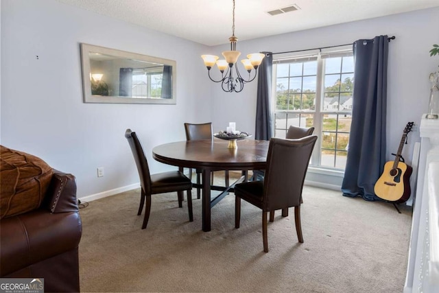 carpeted dining area with an inviting chandelier