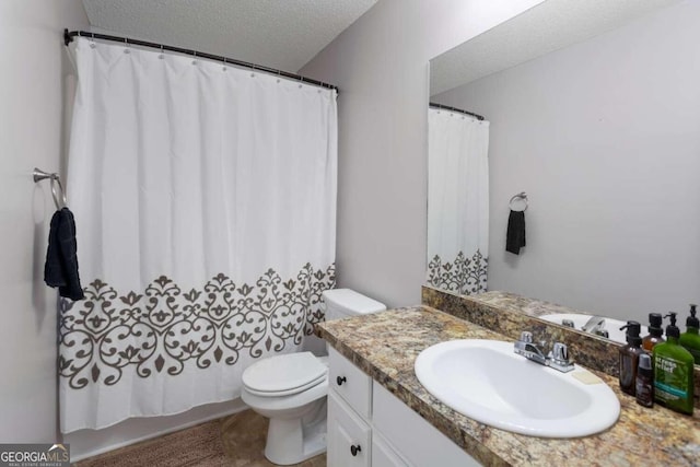 bathroom featuring vanity, toilet, a textured ceiling, and a shower with curtain